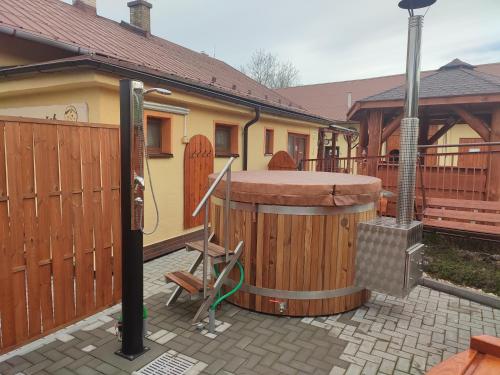 a hot tub on a patio next to a house at Agroturistika - "Domeček u oveček" in Horní Těrlicko