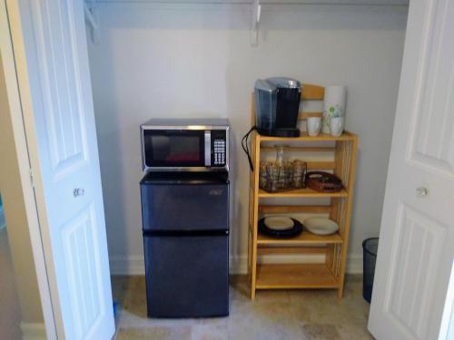 a kitchen with a microwave on top of a refrigerator at Million Dollar Lake View in Orlando