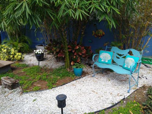 a blue bench sitting in a garden with plants at Million Dollar Lake View in Orlando