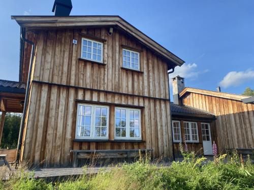 a wooden house with windows on the side of it at Sunny and beautiful cabin in Geilo in Geilo