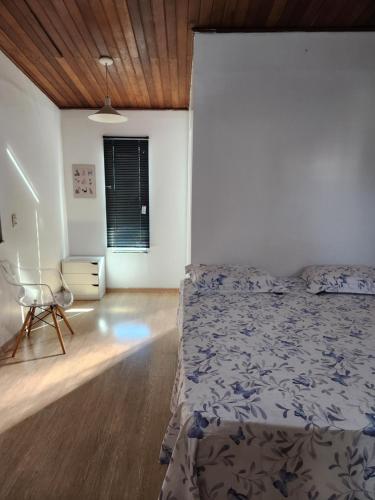 a bedroom with a bed and a chair in it at FLAT W3 Norte in Brasília