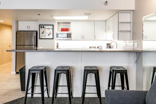 a kitchen with a counter with four bar stools at Silver King by All Seasons Resort Lodging in Park City