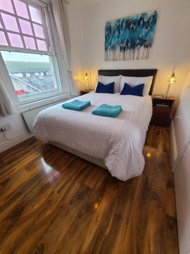 a bedroom with a large bed and a large window at VALE VIEW APARTMENT, Prestatyn, North Wales - a stylish, dog-friendly holiday let just a 5 min walk to beach & town! in Prestatyn