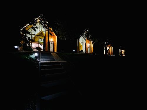 a lit up building at night with lights at MILLAR's in Sovata