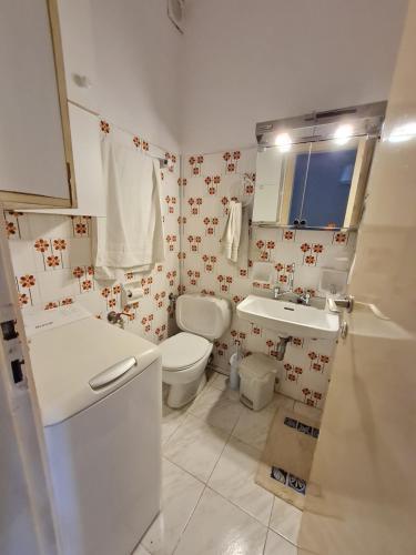 a bathroom with a toilet and a sink at MIRAMARE in Nea Makri