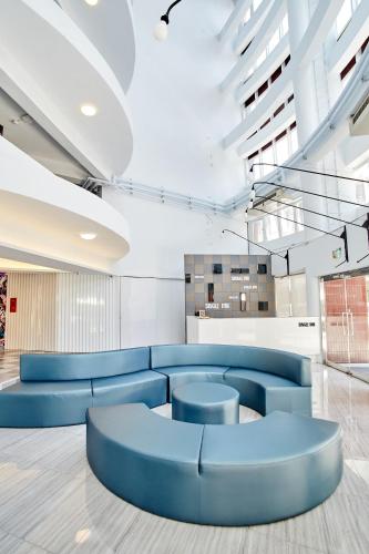 a lobby with blue seating in a building at Single Inn - Taipei in Taipei