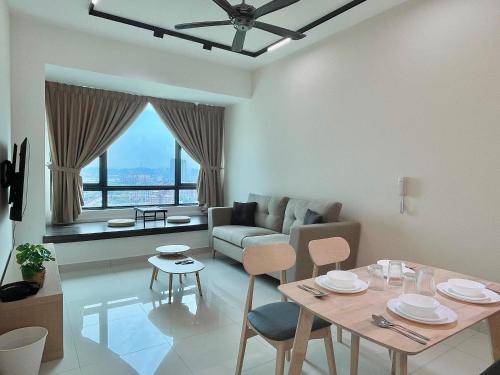 a living room with a table and a couch at Greenfield Residence, Bandar Sunway by The Comfort Zone in Petaling Jaya