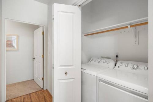 a white laundry room with a washer and dryer at West Sedona Retreat in Sedona