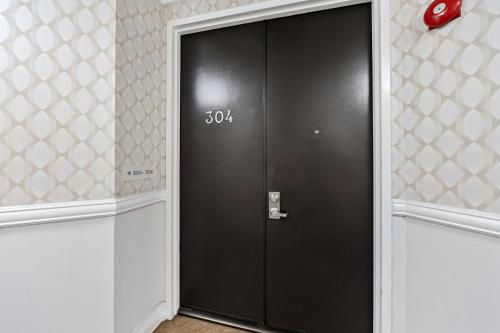a black door in a room with a number on it at Beverly Hills Glamour Oasis 2 BR Apt with Parking 304 in Los Angeles