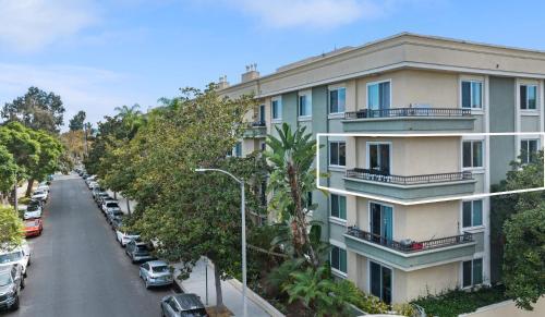 an apartment building with cars parked on a street at Beverly Hills Glamour Oasis 2 BR Apt with Parking 304 in Los Angeles