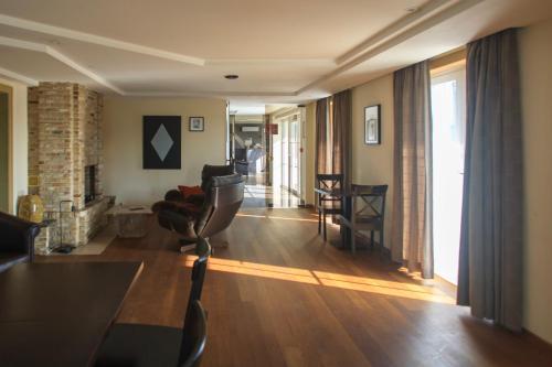 a living room with a elliptical machine in the middle of the room at St-Janshof Hotel in Waregem