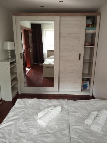 a bedroom with a bed with two towels on it at A&D in Reşiţa