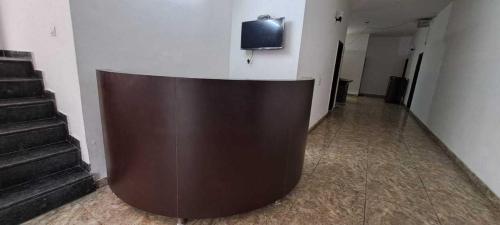 a brown wooden partition in a hallway with stairs at OYO Naveen Residancy in Gurgaon