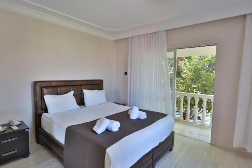 a bedroom with a bed with two pillows and a balcony at House w Pool Balcony 5 min to Beach in Kyrenia in Kyrenia