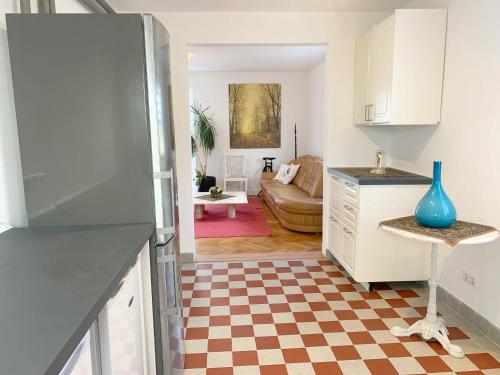 a kitchen and living room with a checkered floor at Sunny Freudenstadt in Freudenstadt