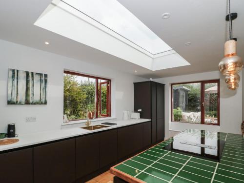 a kitchen with a large skylight in the ceiling at Orchard End in Glastonbury