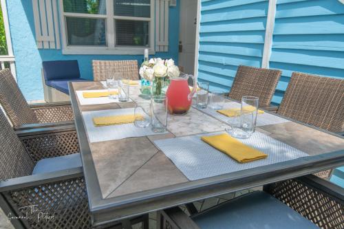 a table with a vase and flowers on a patio at Steps to Private Beach - Sand, Surf, Sun - 2bd,2ba in Fort Pierce