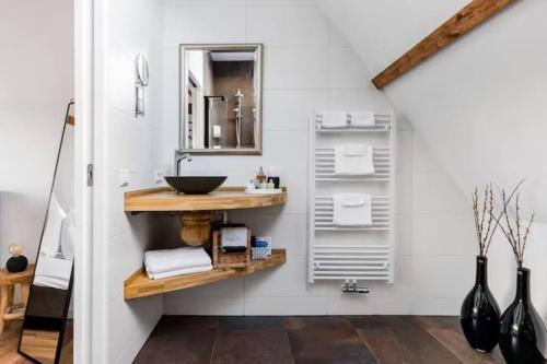 a bathroom with a sink and a mirror at BBWestduin in The Hague