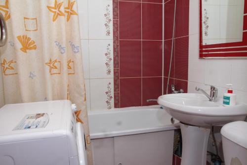a bathroom with a sink and a toilet and a bath tub at Монтана in Petropavlovsk