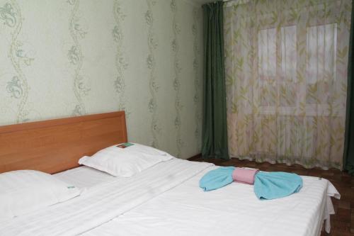 a bedroom with two beds with towels on them at Монтана in Petropavlovsk
