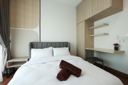 a bedroom with a bed with a towel on it at Greenfield Residence, Bandar Sunway by The Comfort Zone in Petaling Jaya