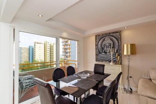 a dining room with a table and a large window at The White Apartment: Luxury, Beach and Design in Valencia