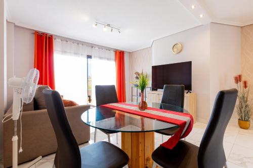 een woonkamer met een tafel en een bank bij Beautiful, quiet apartment with heated pool AP236 in San Miguel de Abona