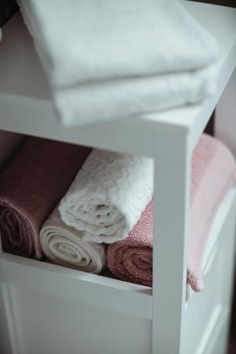 a white shelf with towels in a closet at Apartmany pod Pustevnami in Prostřední Bečva