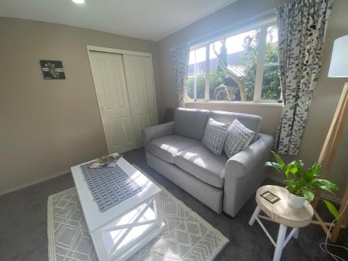 a living room with a couch and a table at The Ground Floor Guest Suite in Dunedin