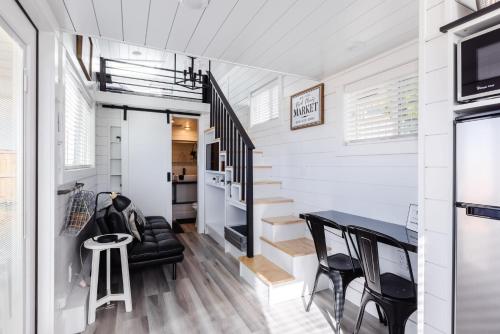 a tiny house with a staircase and a dining room at Zion Basecamp, Tiny Home Near National Park in Apple Valley