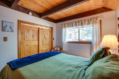 a bedroom with a large bed and a window at 10 Mi to Lake Tahoe Beaches Home with Pool Table in South Lake Tahoe