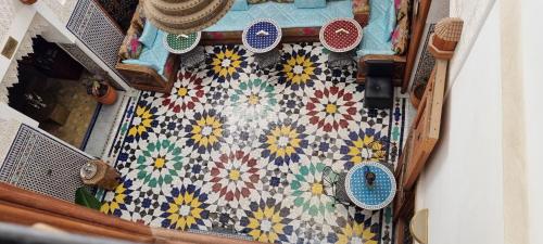 an overhead view of a table with a patterned floor at Riad Fes Touria Palace in Fès