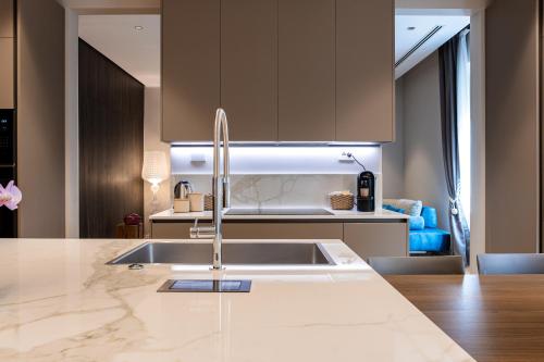 a kitchen with a sink and a counter top at La Dolce Vita Luxury Apartment in Rome