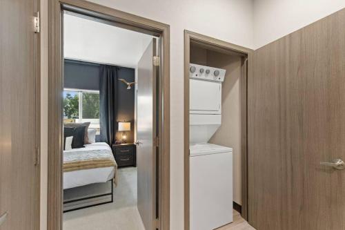 a small bedroom with a bed and a window at Brand New 2BD 1 5BTH Triplex Unit Near Downtown in Spokane