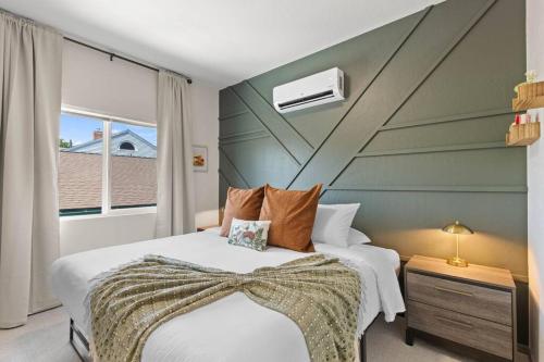 a bedroom with two beds and a large window at Brand New 2BD 1 5BTH Triplex Unit Near Downtown in Spokane