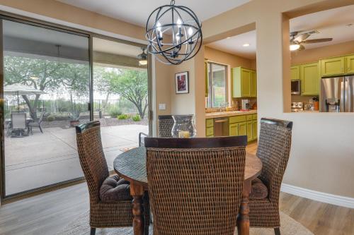 a kitchen with a table and chairs and a chandelier at Patio and Golf Course Views at Home in Anthem! in Anthem