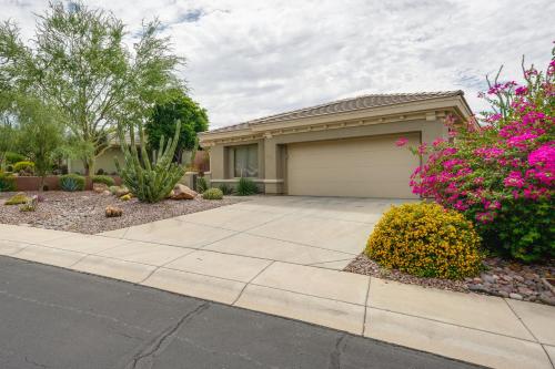 a house with a garage and flowers at Patio and Golf Course Views at Home in Anthem! in Anthem