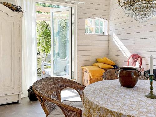 a dining room with a table and chairs and a porch at 4 star holiday home in TOMELILLA-By Traum in Tomelilla
