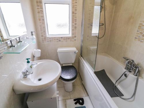 a bathroom with a sink and a toilet and a shower at Shore Road in Culdaff