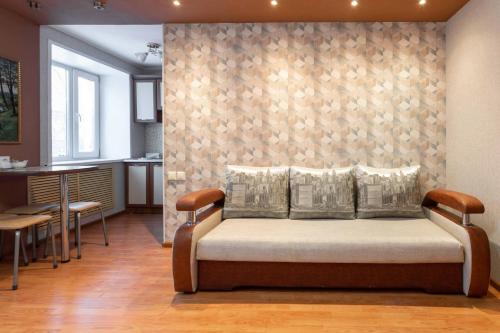 a bedroom with a bed and a kitchen with a table at Палермо in Petropavlovsk