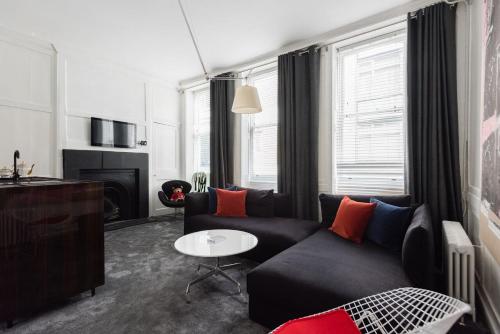 a living room with a couch and a table at Welcome London Soho in London