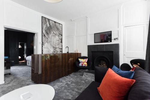 a living room with a couch and a fireplace at Welcome London Soho in London
