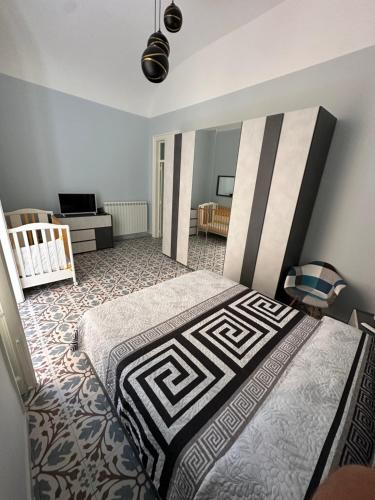 a bedroom with a bed and a crib in it at Elisir house in Palermo