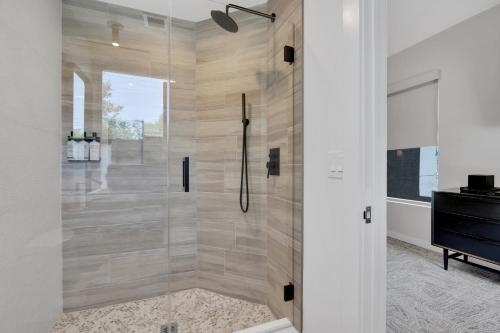 a shower with a glass door in a bathroom at The St Laurent Guest Rooms in Asbury Park