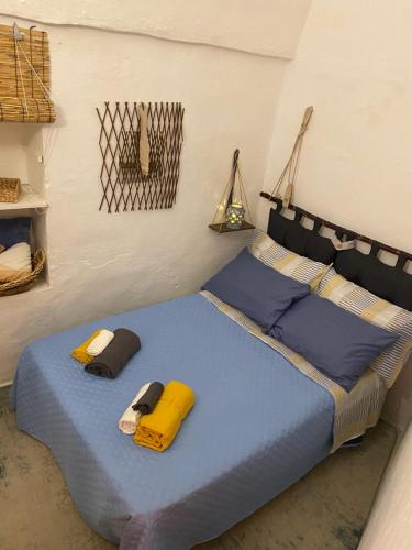 a bed in a room with two pillows on it at TumHouse (la capanna di zio Tom) in Ceglie Messapica