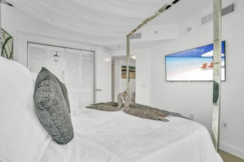 een witte slaapkamer met een groot bed met kussens bij Modern 2 Story Loft 2BR with Breathtaking Views in Miami