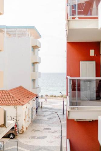 a view of the beach from the balcony of a building at Sunset in Armação de Pêra
