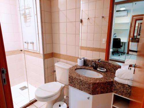 a bathroom with a toilet and a sink and a shower at Nobile Flat Particular G07 in Brasilia