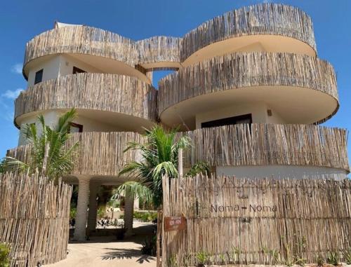 a building with a wooden fence in front of it at Casa Noma-Noma Holbox in Holbox Island