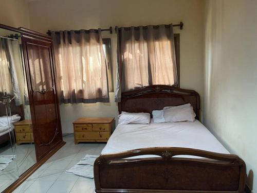 een slaapkamer met een groot houten bed en een spiegel bij Villa Thomas 